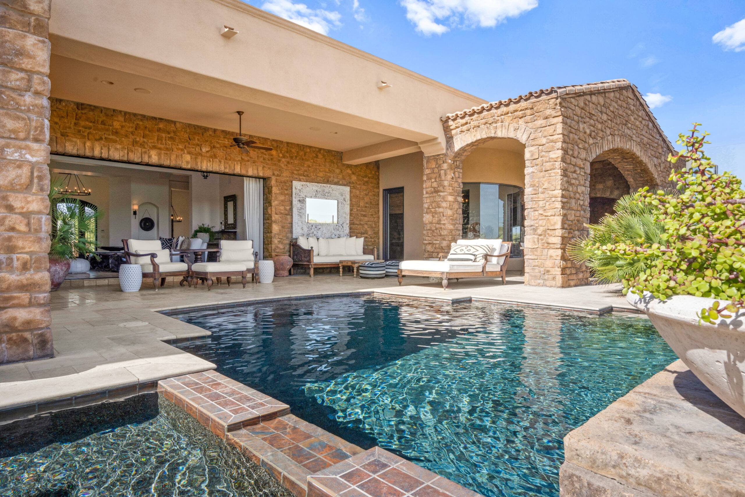 A pool that is in the middle of a patio.